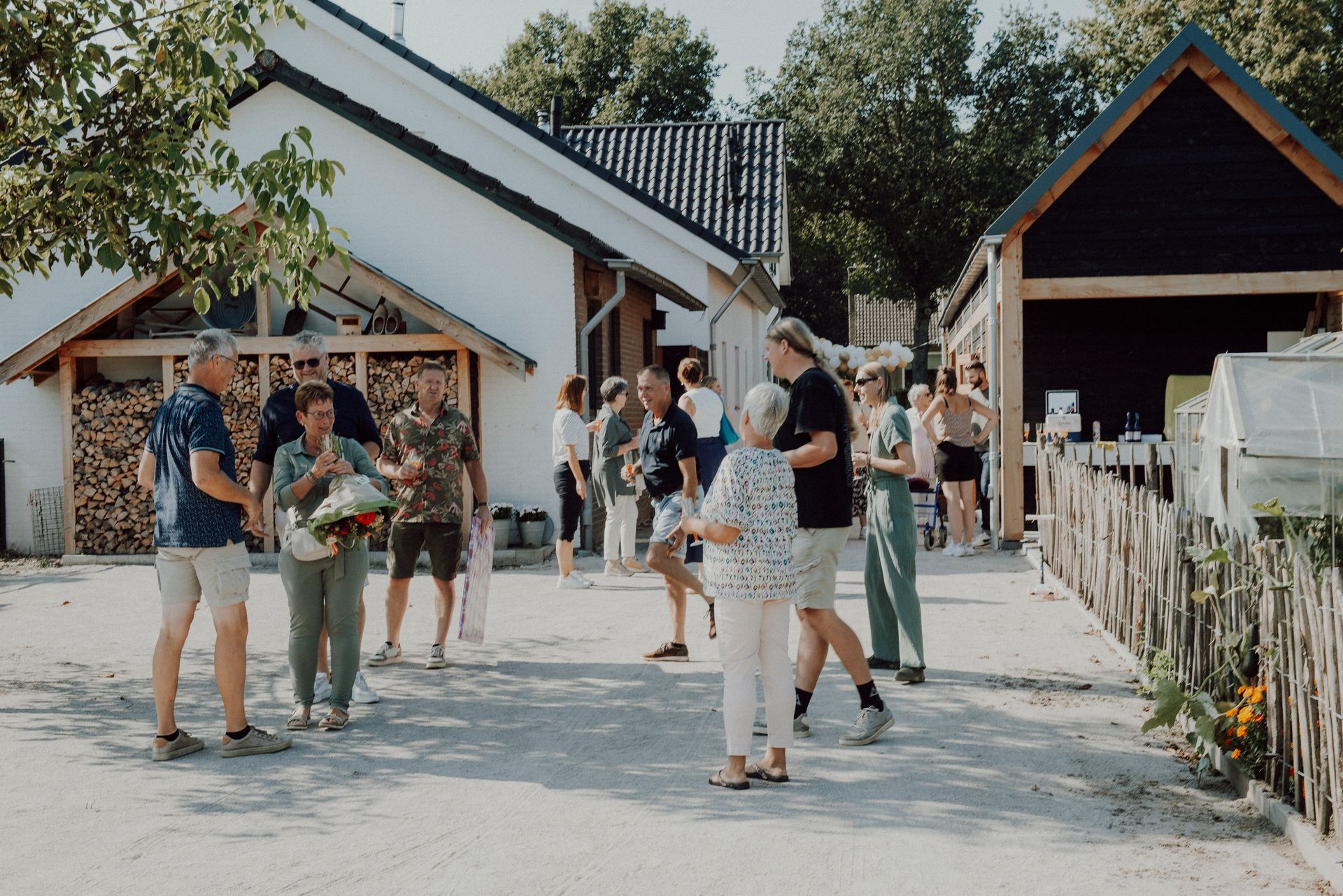 Mensen hadden zich verzameld buiten witte en zwarte gebouwen. Het was een zonnige dag.