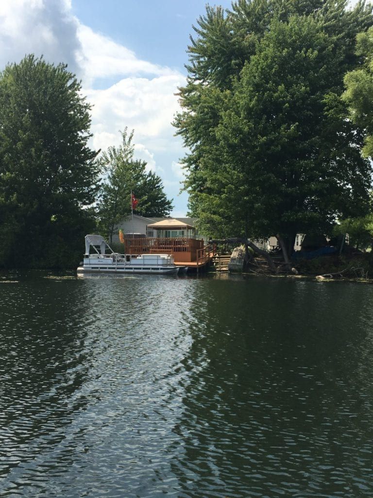 A boat is floating on a lake with trees in the background
