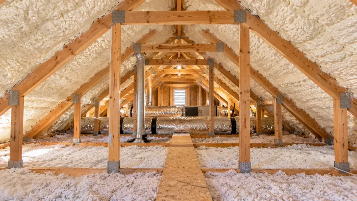 Finished attic with spray foam insulation and exposed roof trusses in Odessa, TX.