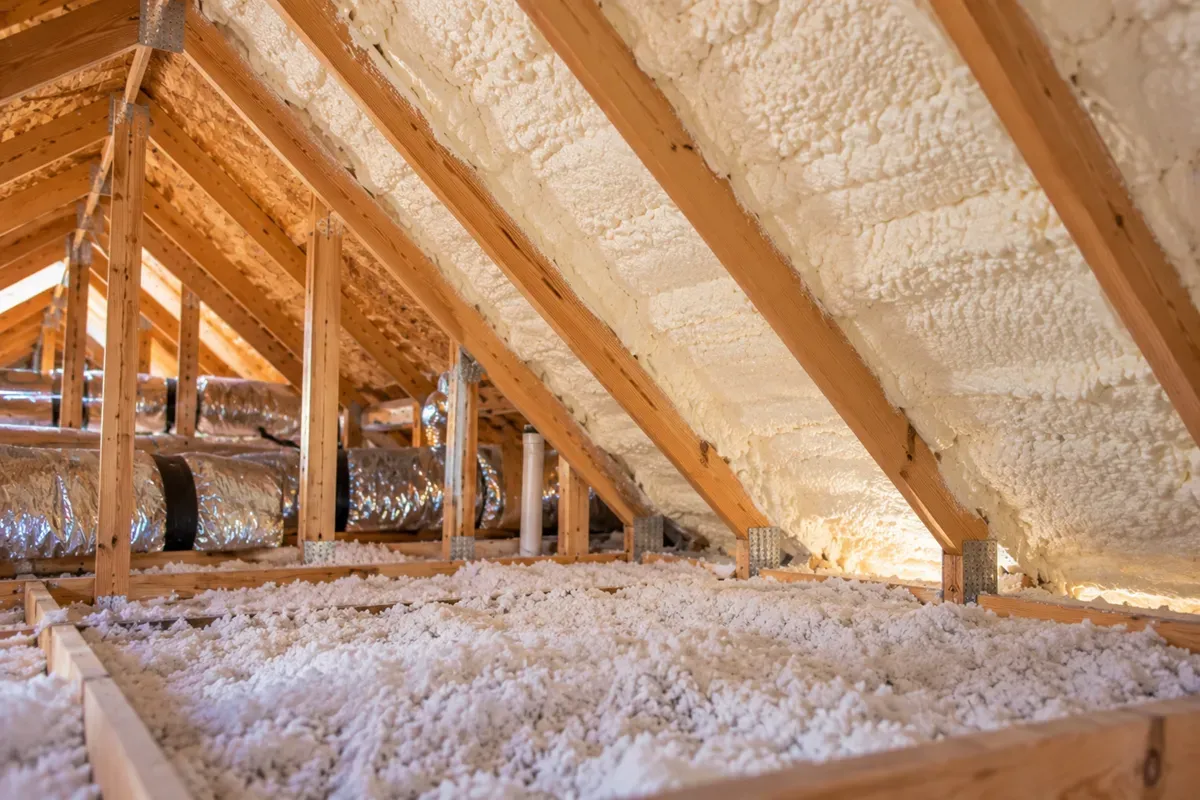 Completed attic with spray foam insulation along roof rafters in Odessa, TX.