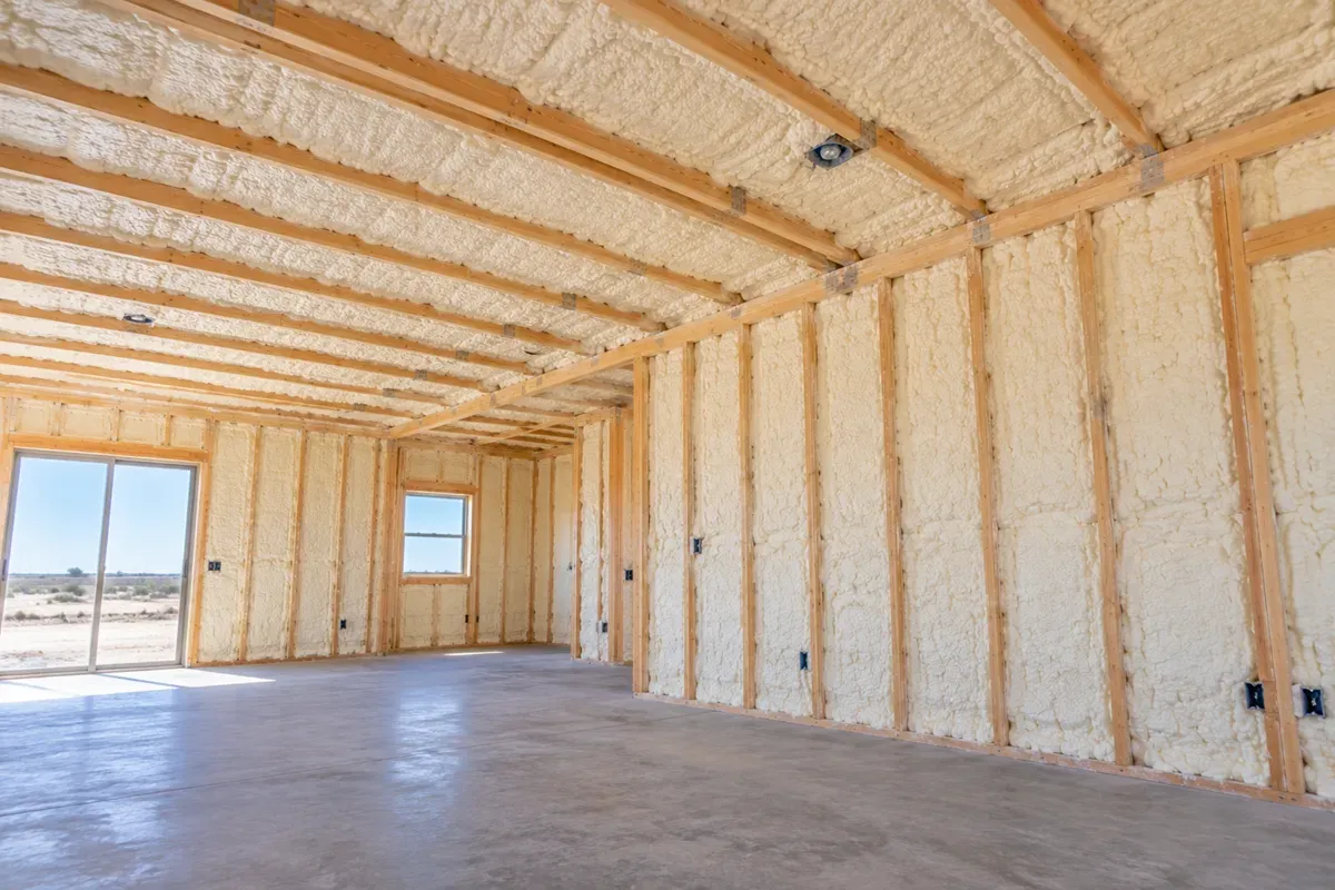 Completed open-cell spray foam insulation on ground-floor walls and ceiling in Odessa, Texas.