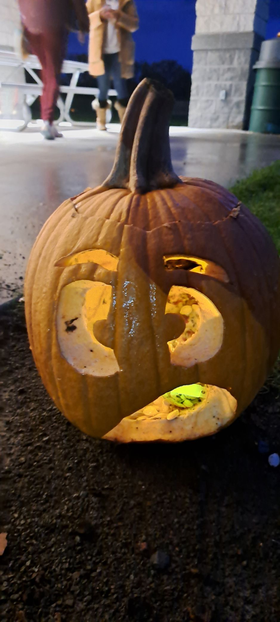 A carved pumpkin with a surprised expression lit up from within.