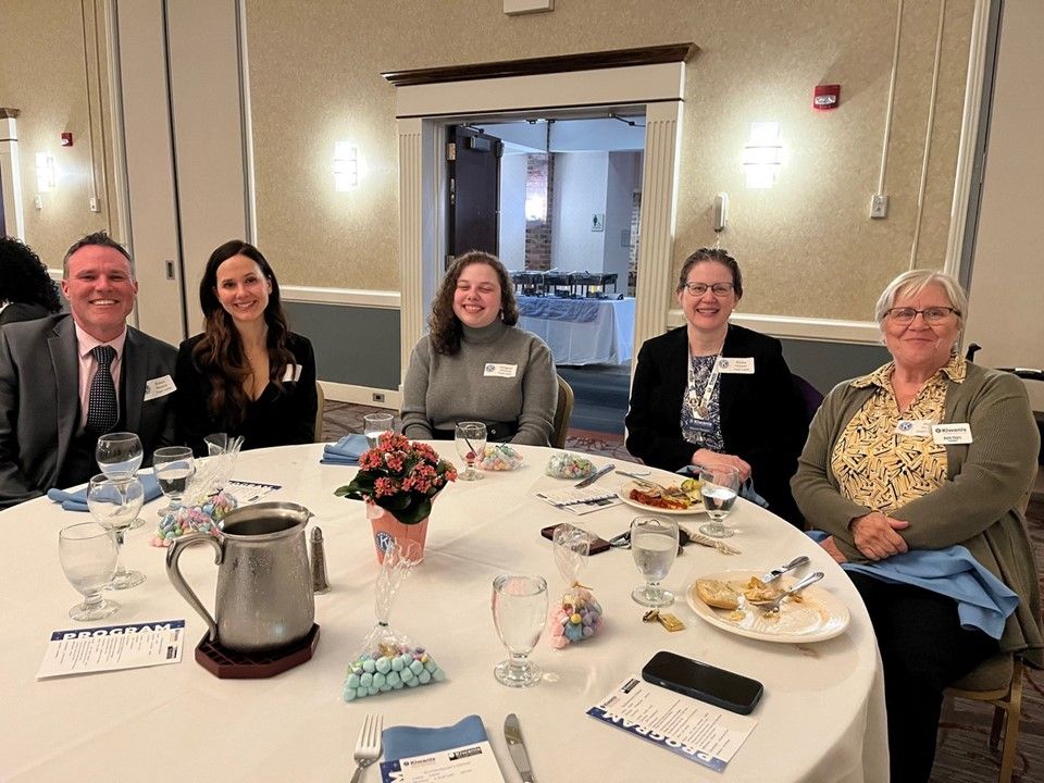 Group photo of 5 people sitting at a table