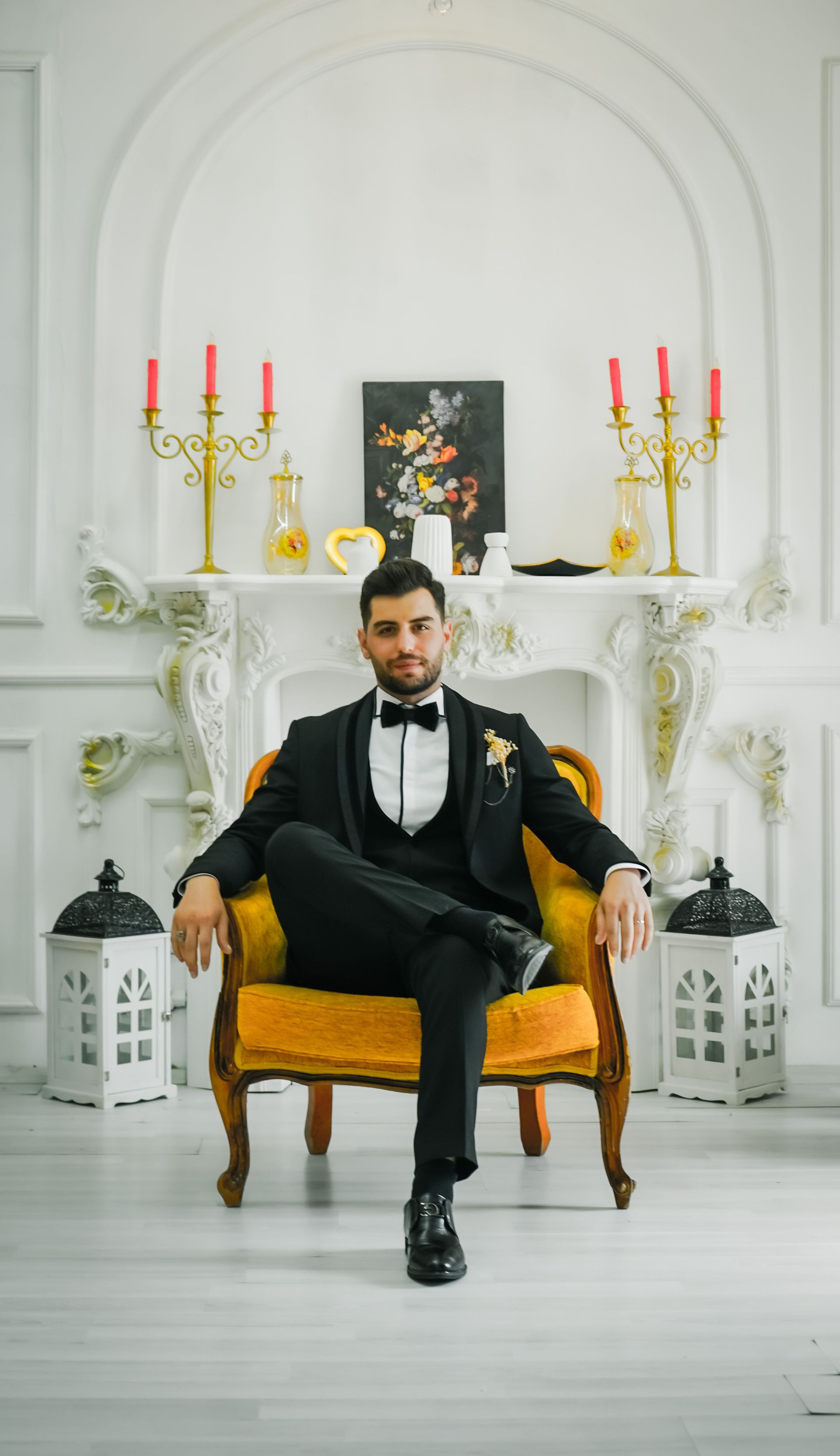 Mannequins dressed in black tuxedos with white pocket squares and neckties on display