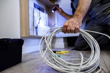 Man Working with Internet Cables — Electrician in Tamworth, NSW
