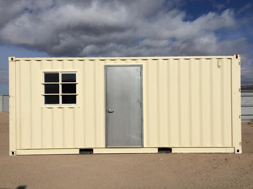 A white shipping container with a door and a window