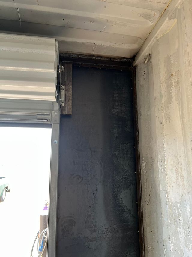A close up of a door with a roller shutter on it