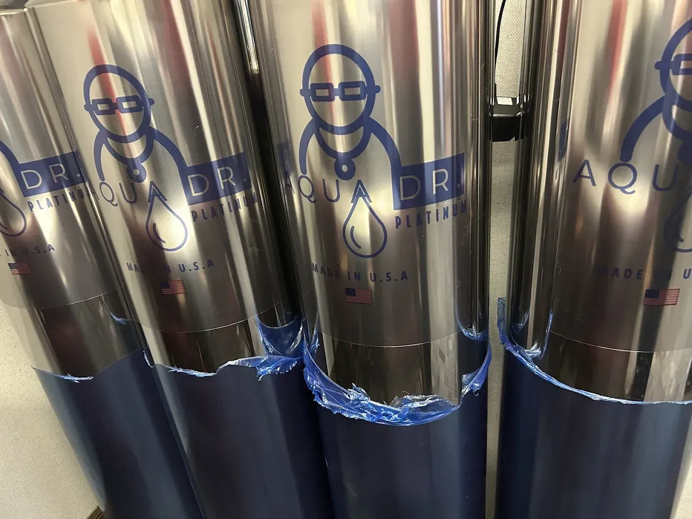 Silver and blue Aqua Drop water filter rolls with logo.