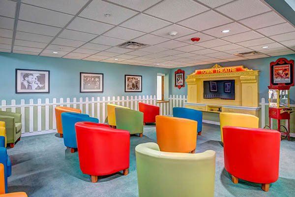 A room filled with colorful chairs and a television.