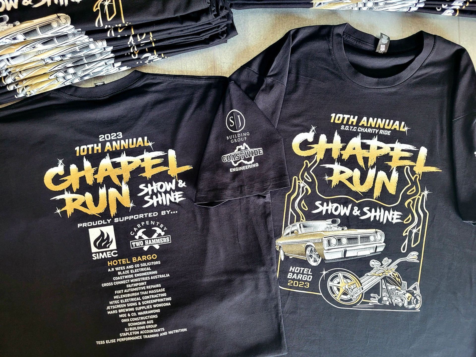 A stack of chapel run shirts are sitting on a table