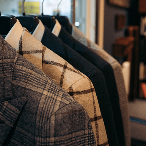 A row of jackets are hanging on a rack in a store