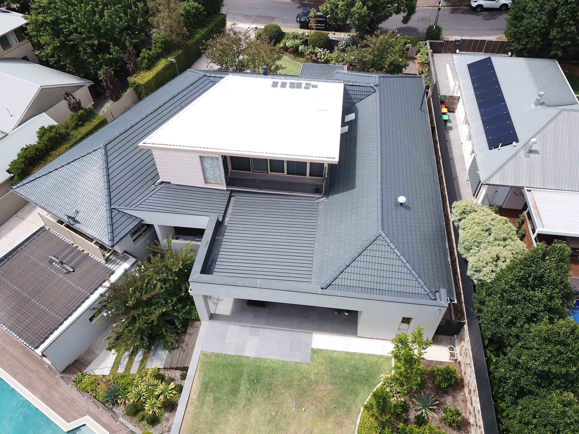An aerial view of a house with a white roof