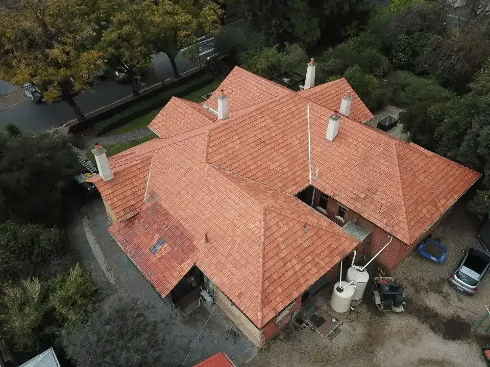 An aerial view of a house with a red tiled roof