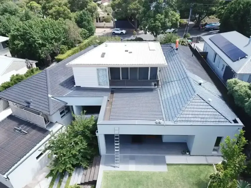 An aerial view of a house with a black roof