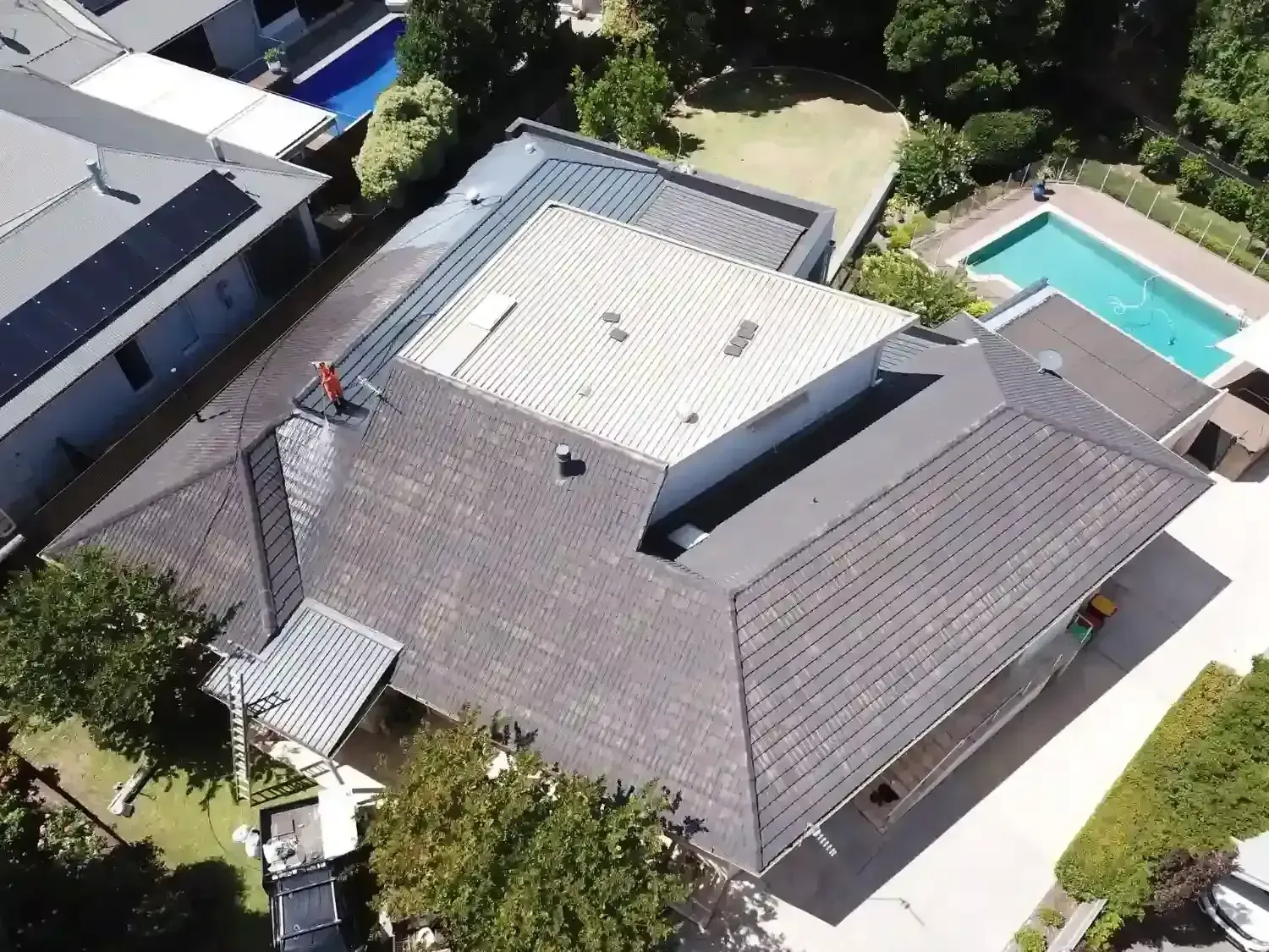 An aerial view of a house with a pool in the backyard