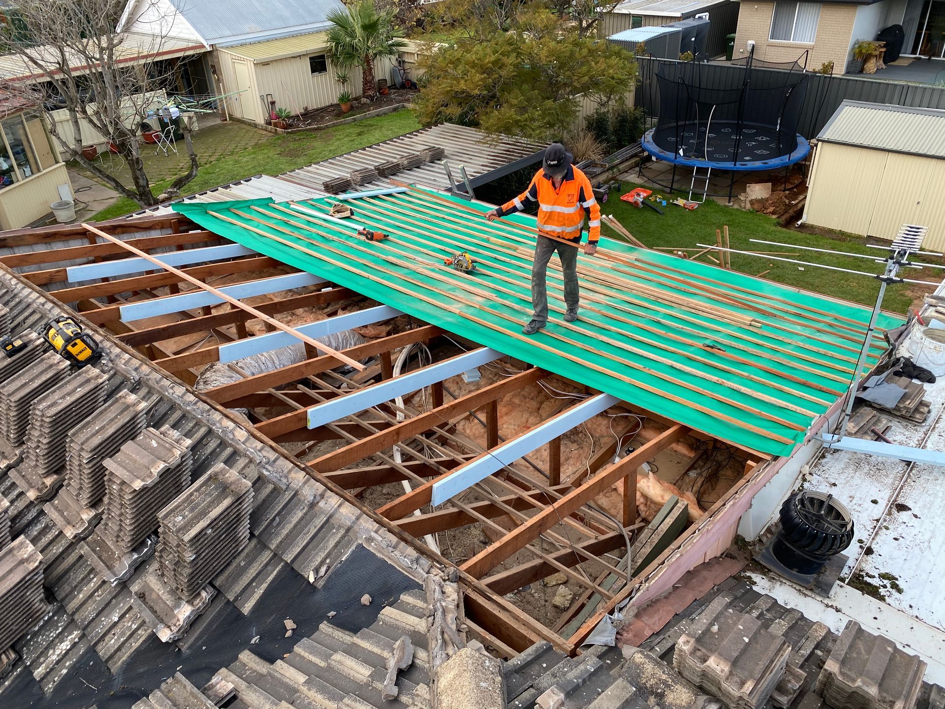 A man is standing on top of a roof.