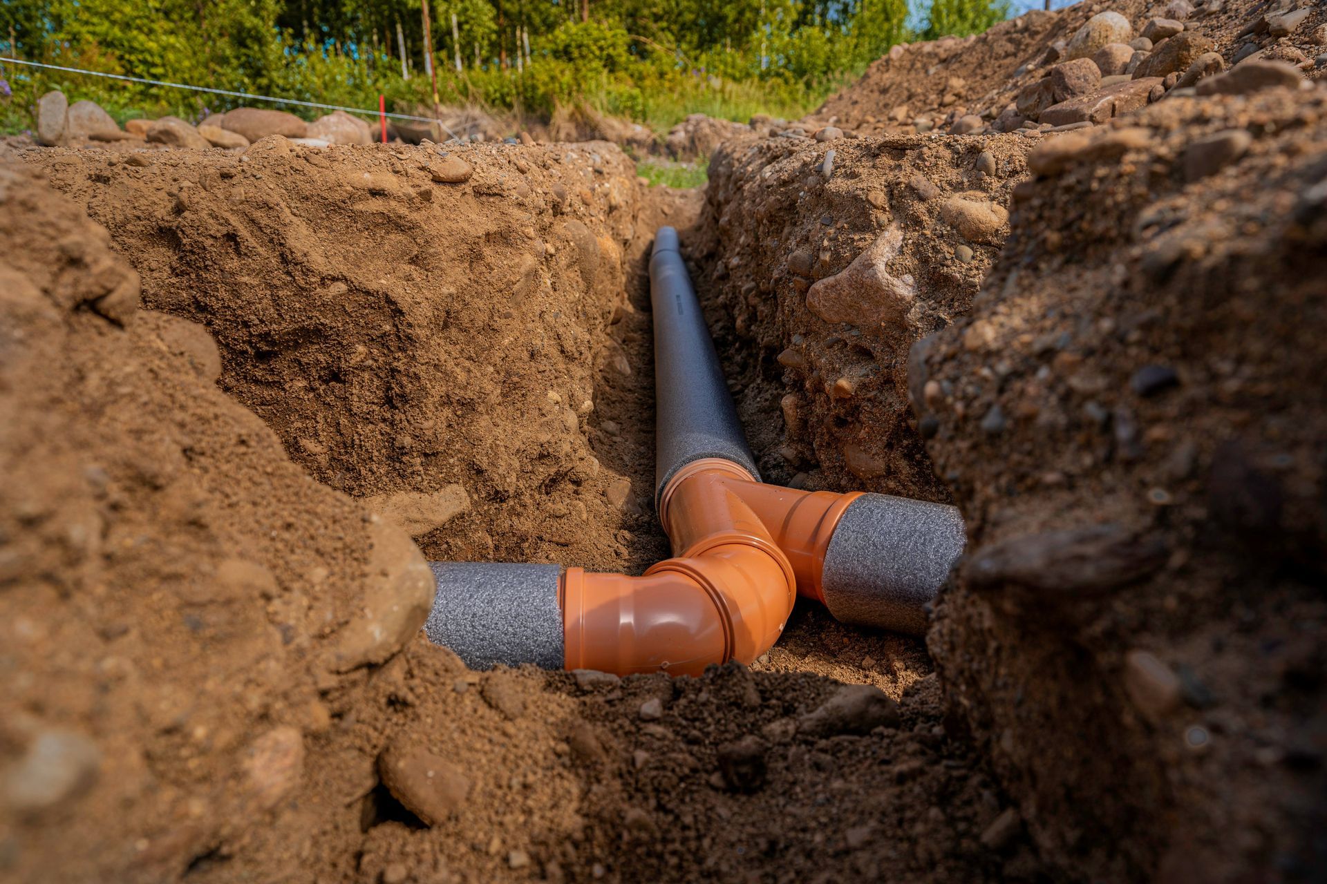 Laying sewer pipes in the ground under the foundation.