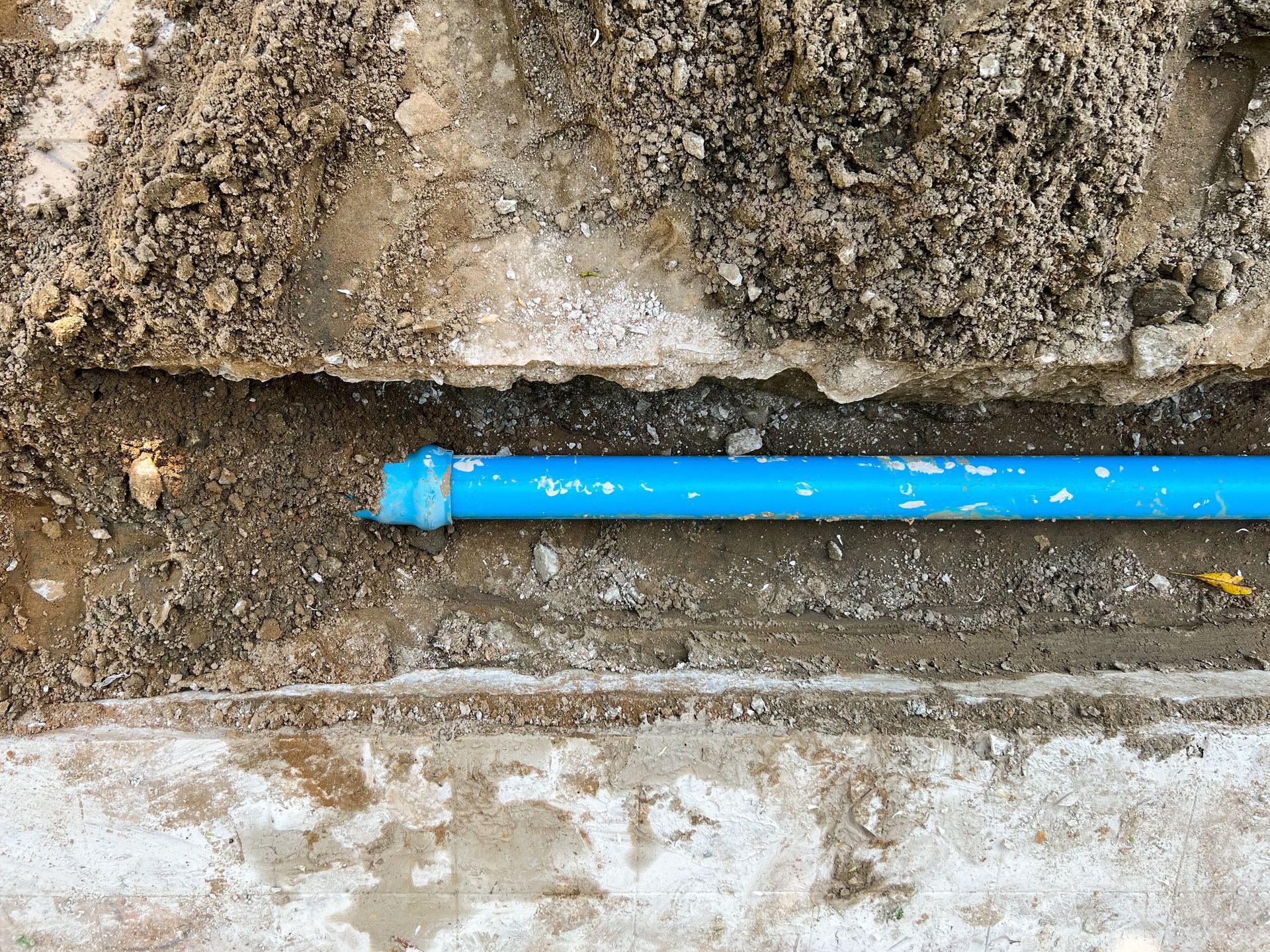 A PVC pipe installed in a trench for an underground water main line. A PVC pipe installed in a trench for an underground water main line.