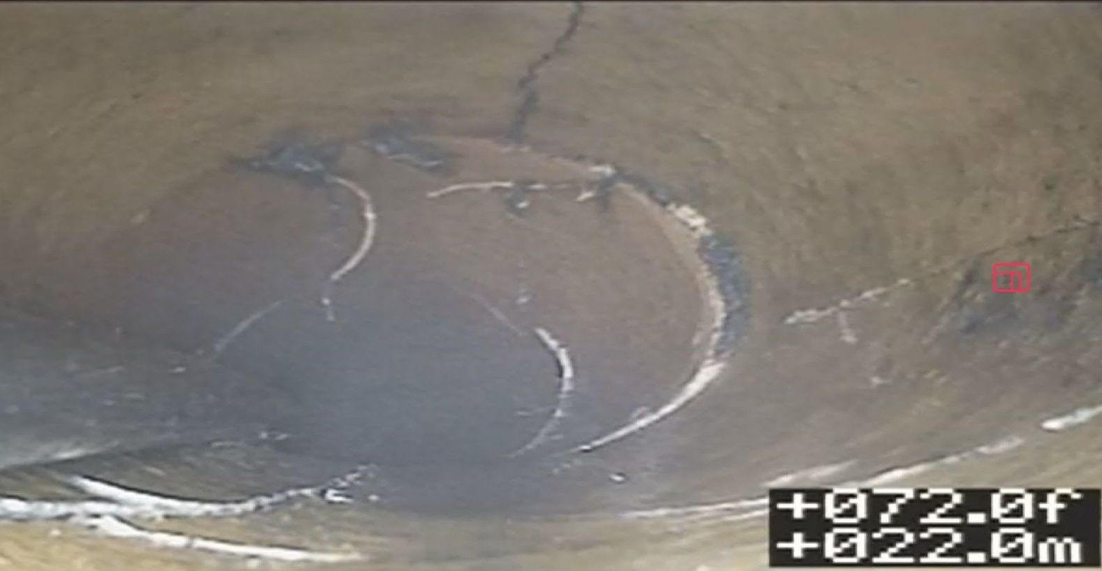 A CCTV pipe inspection showing a longitudinal crack and a circumferential fracture in the pipe wall at the 72-foot mark.