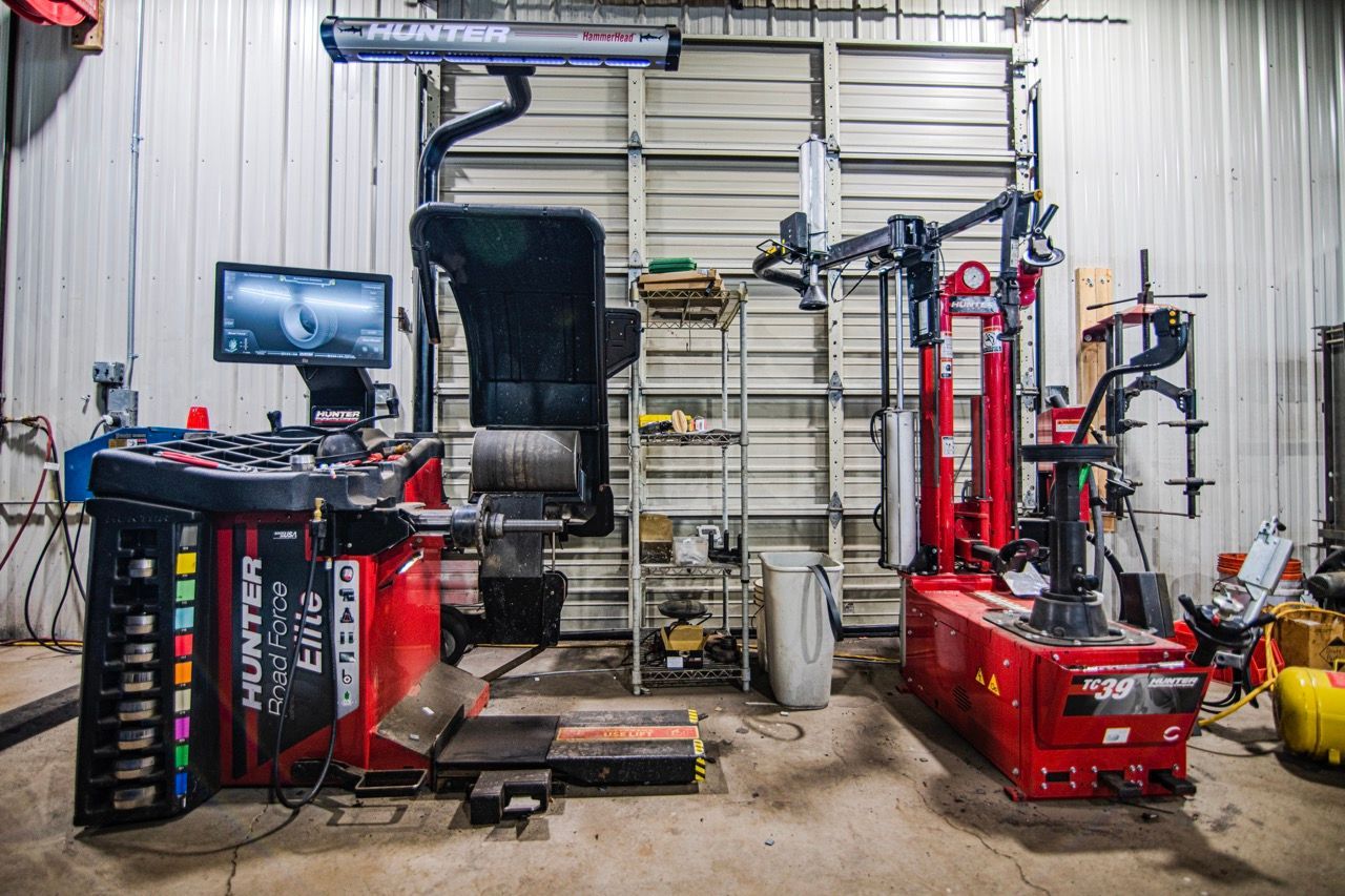 Red Hunter tire equipment in a garage; a tire balancer and changer | Jackson, MI