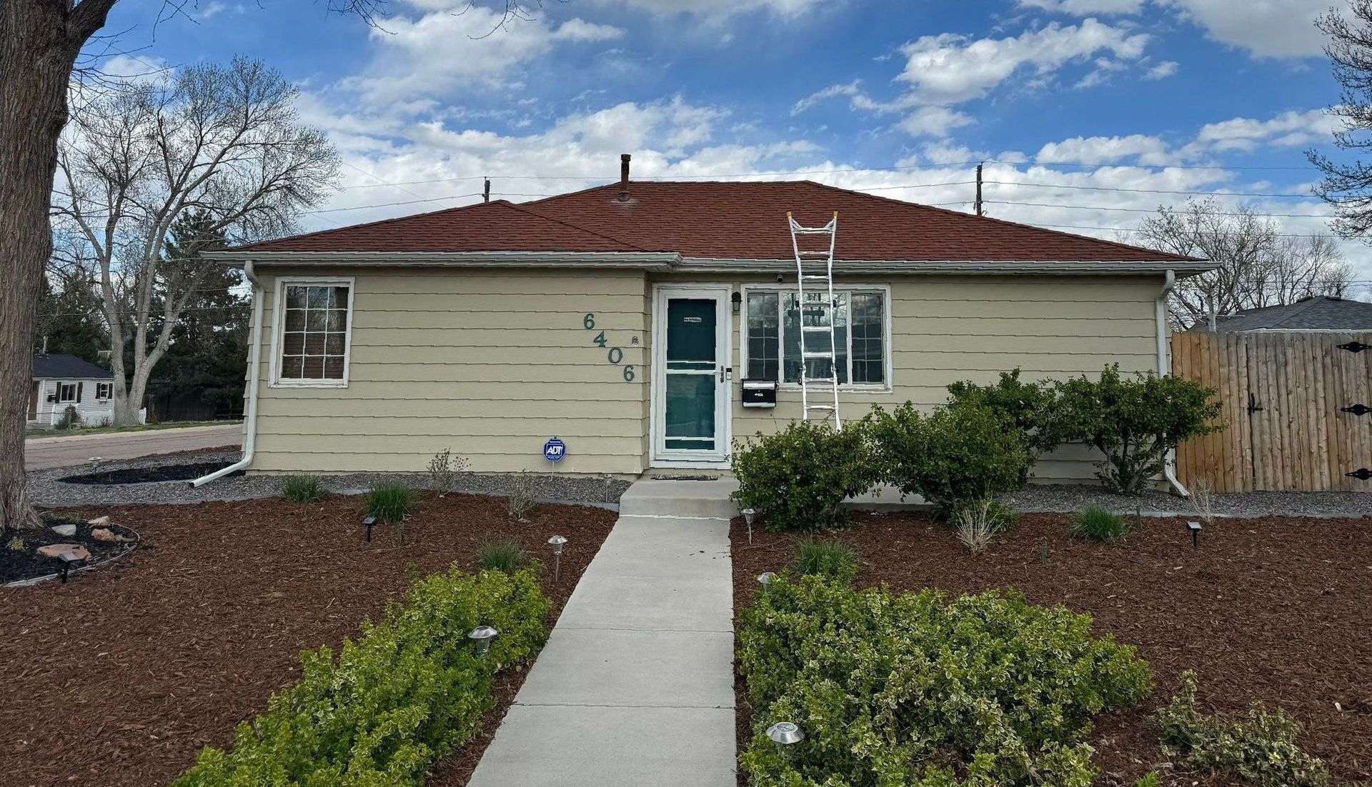 A house under construction with a pile of dirt in front of it