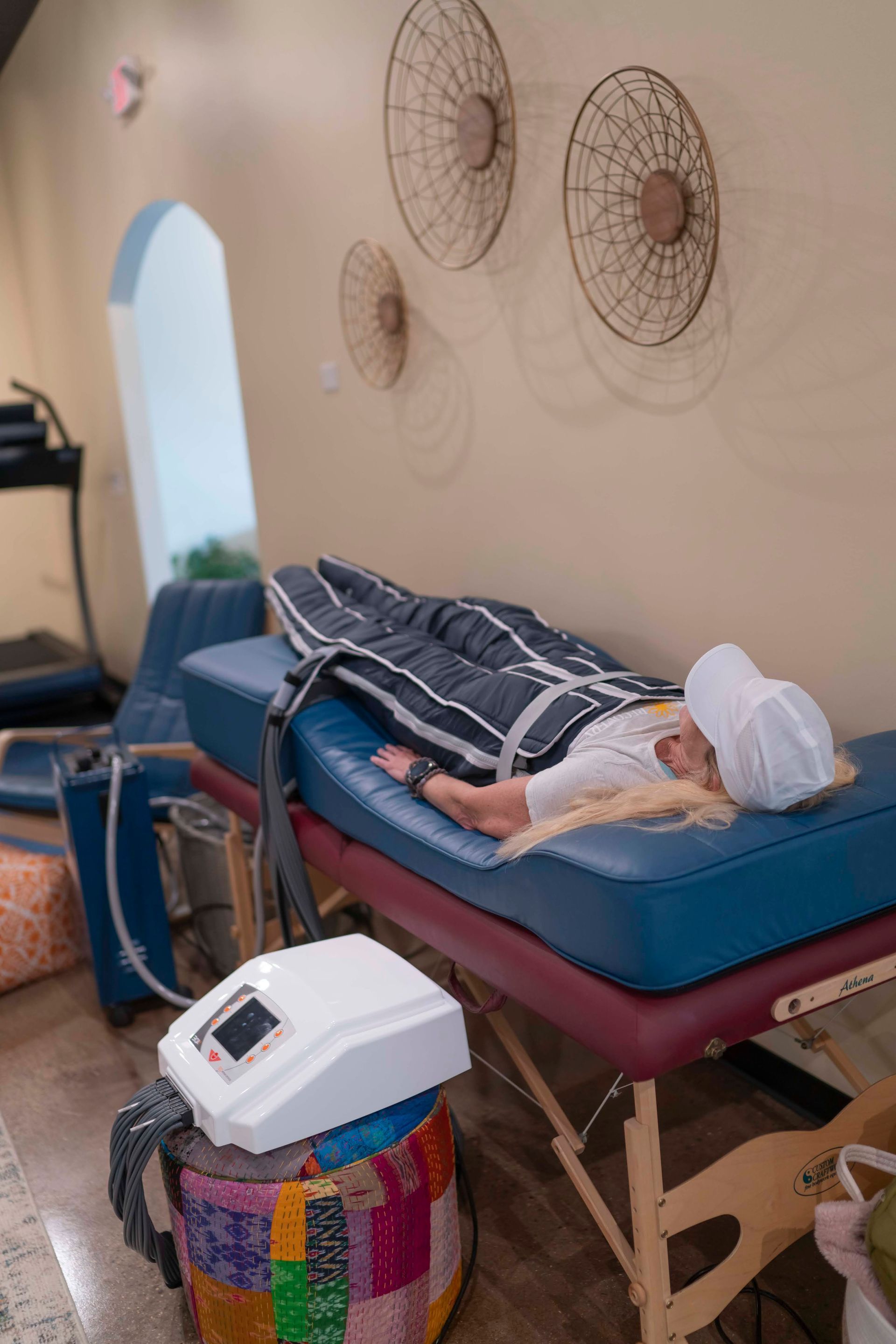 A woman is laying on a bed getting a massage.