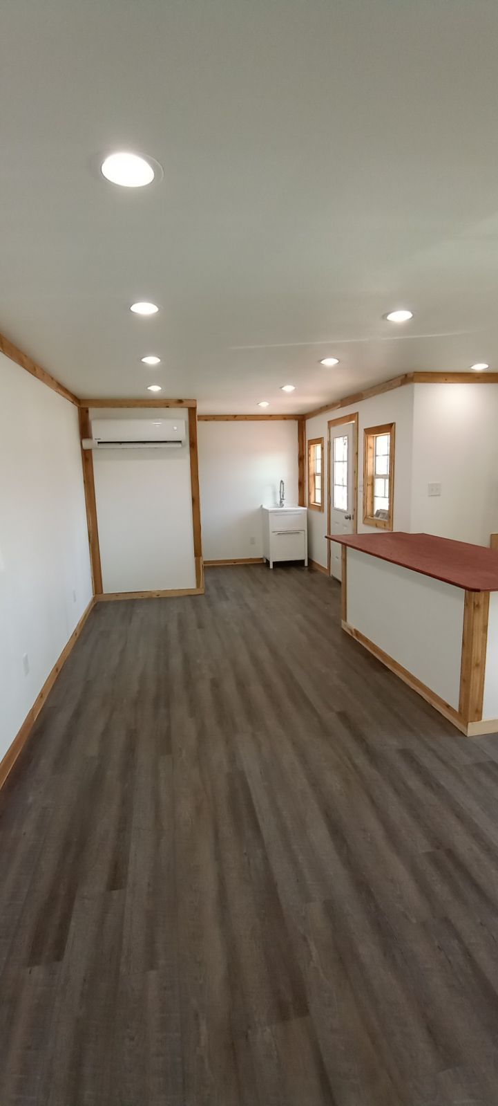 A room with a wooden floor and gray walls.