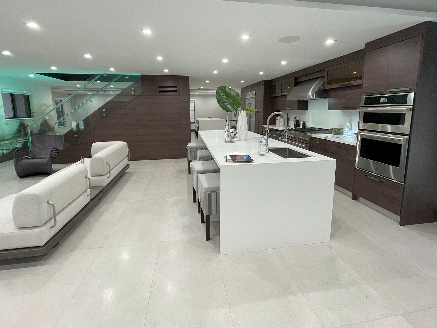 A kitchen with a large island and stainless steel appliances