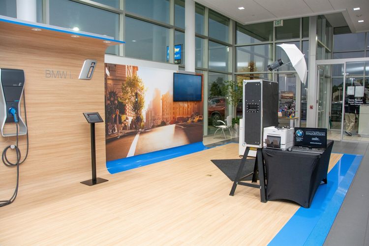 A bmw showroom with a wooden wall and a table