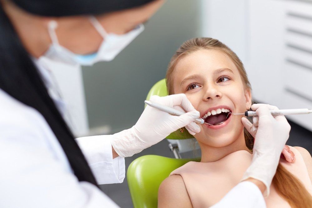 Dentist Examining a Young Person's Teeth in a Dental Office — Tamworth Orthocare In Tamworth, NSW
