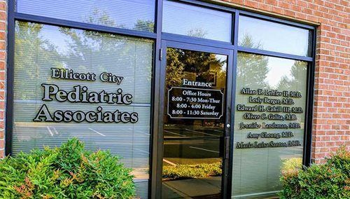 Exterior of Elmer City Pediatric Associates office with brick facade and glass entrance doors