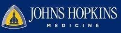 Johns Hopkins Medicine logo with blue banner, gold shield emblem, and white text