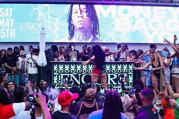 Crowd at Encore club watching Moneybagg Yo perform on stage.