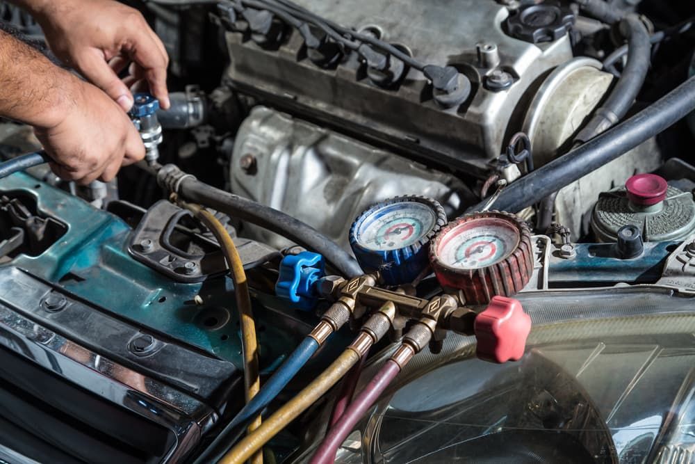 A Man is Working on the Engine of a Car — Coffs Auto Service in North Boambee Valley, NSW