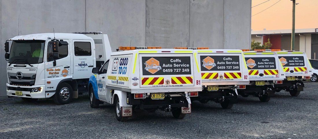 A Row of Tow Trucks Parked Next to Each Other in a Parking Lot — Coffs Auto Service in North Boambee Valley, NSW