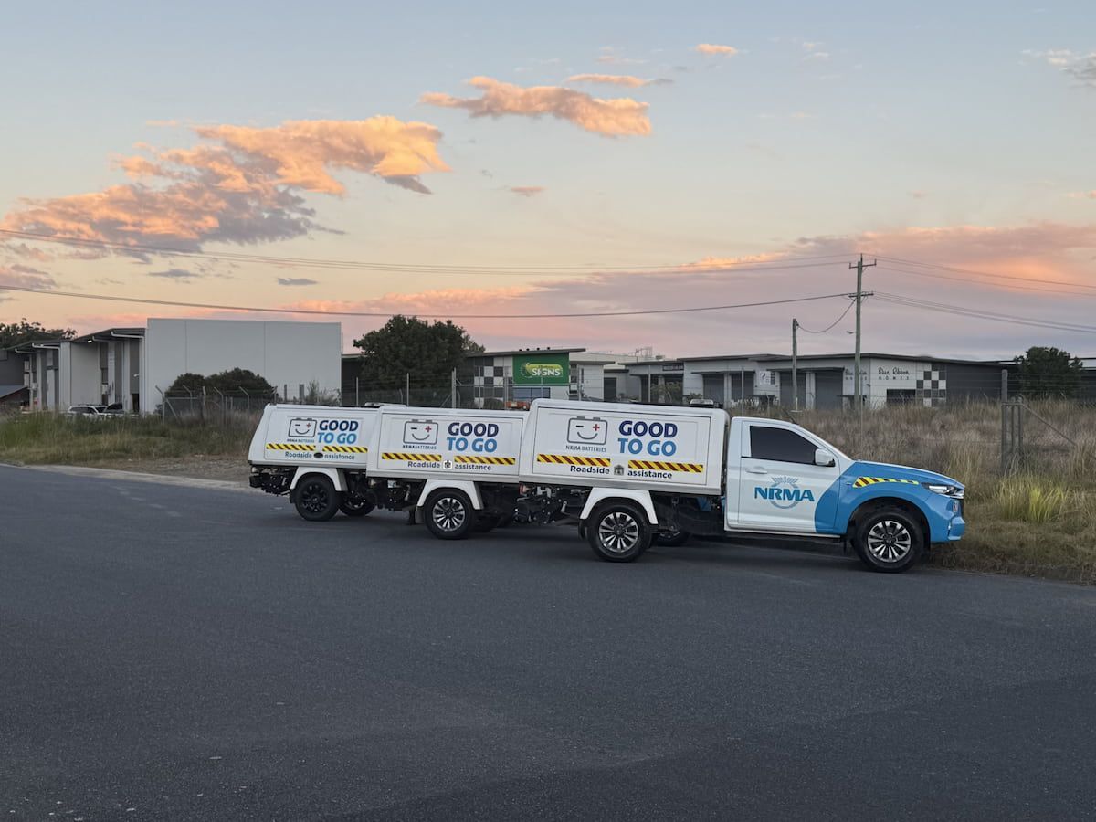 White-and-blue Utility Truck With Trailer Parked — Coffs Auto Service in North Boambee Valley, NSW