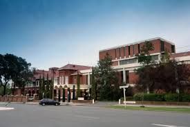 A large brick building with a car parked in front of it.