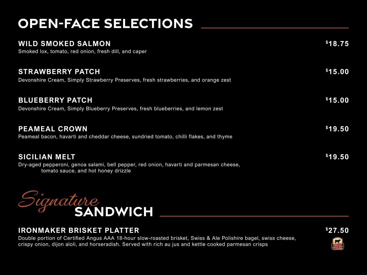Menu board of open-face sandwich selections with item names and prices on a black background