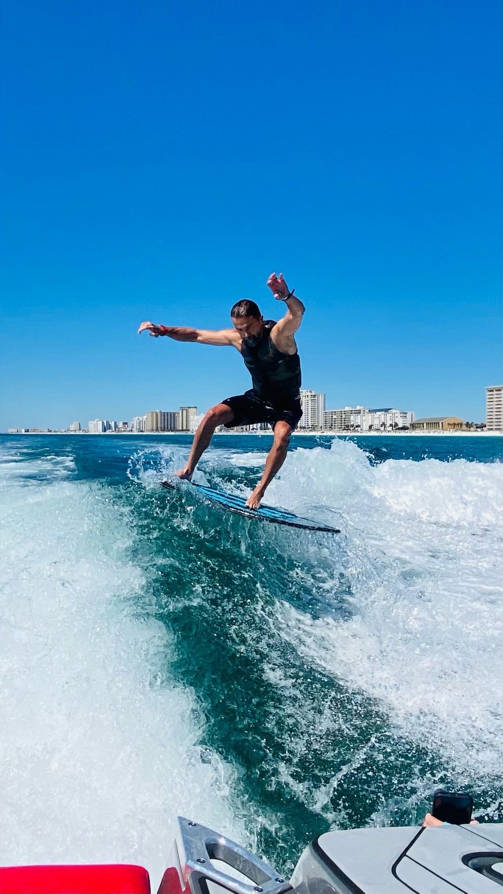A man is riding a wave on a surfboard in the ocean.