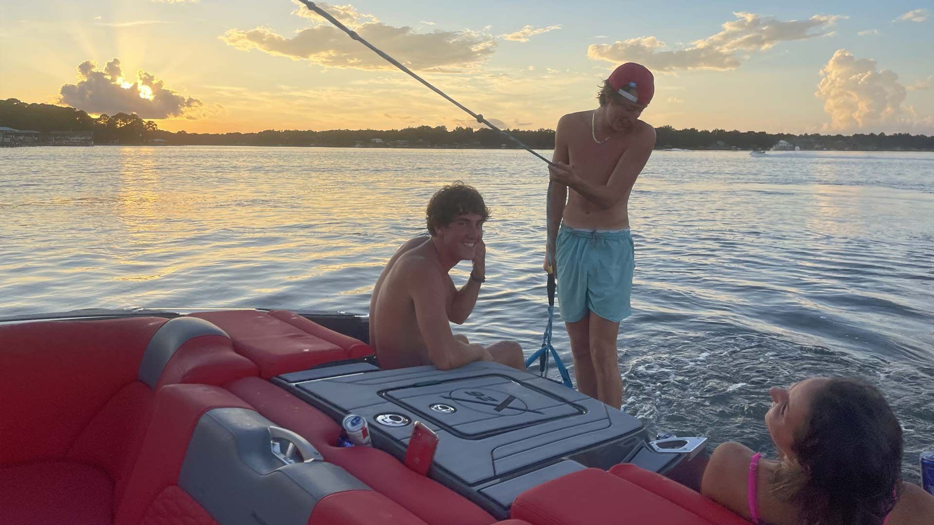 A group of people are standing on a boat in the water.