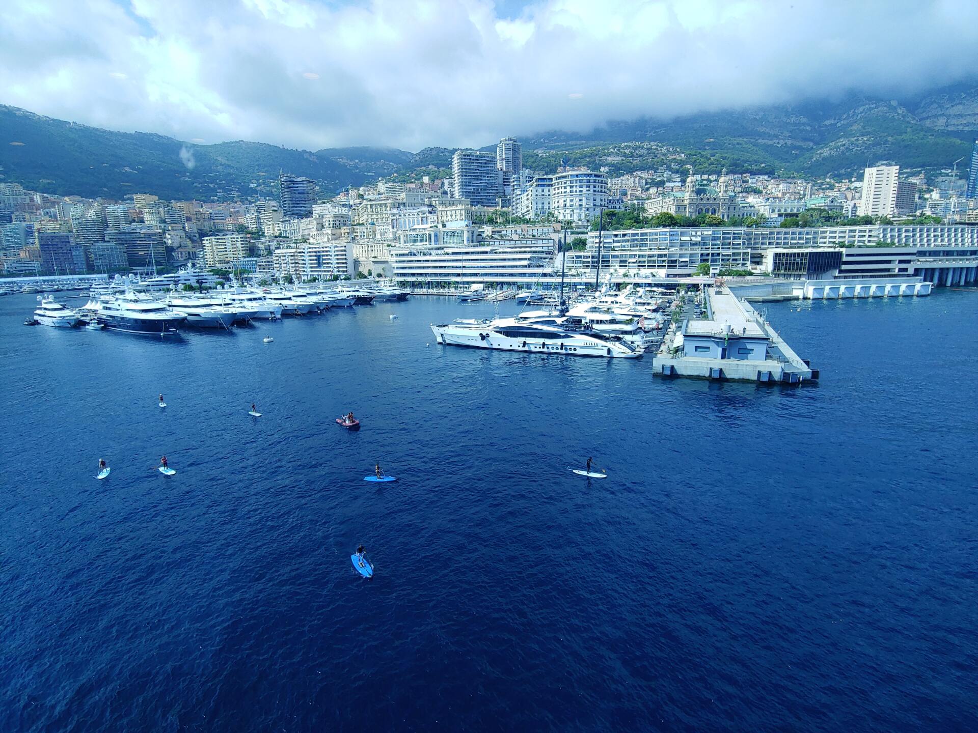 An aerial view of a marina with boats and a city in the background