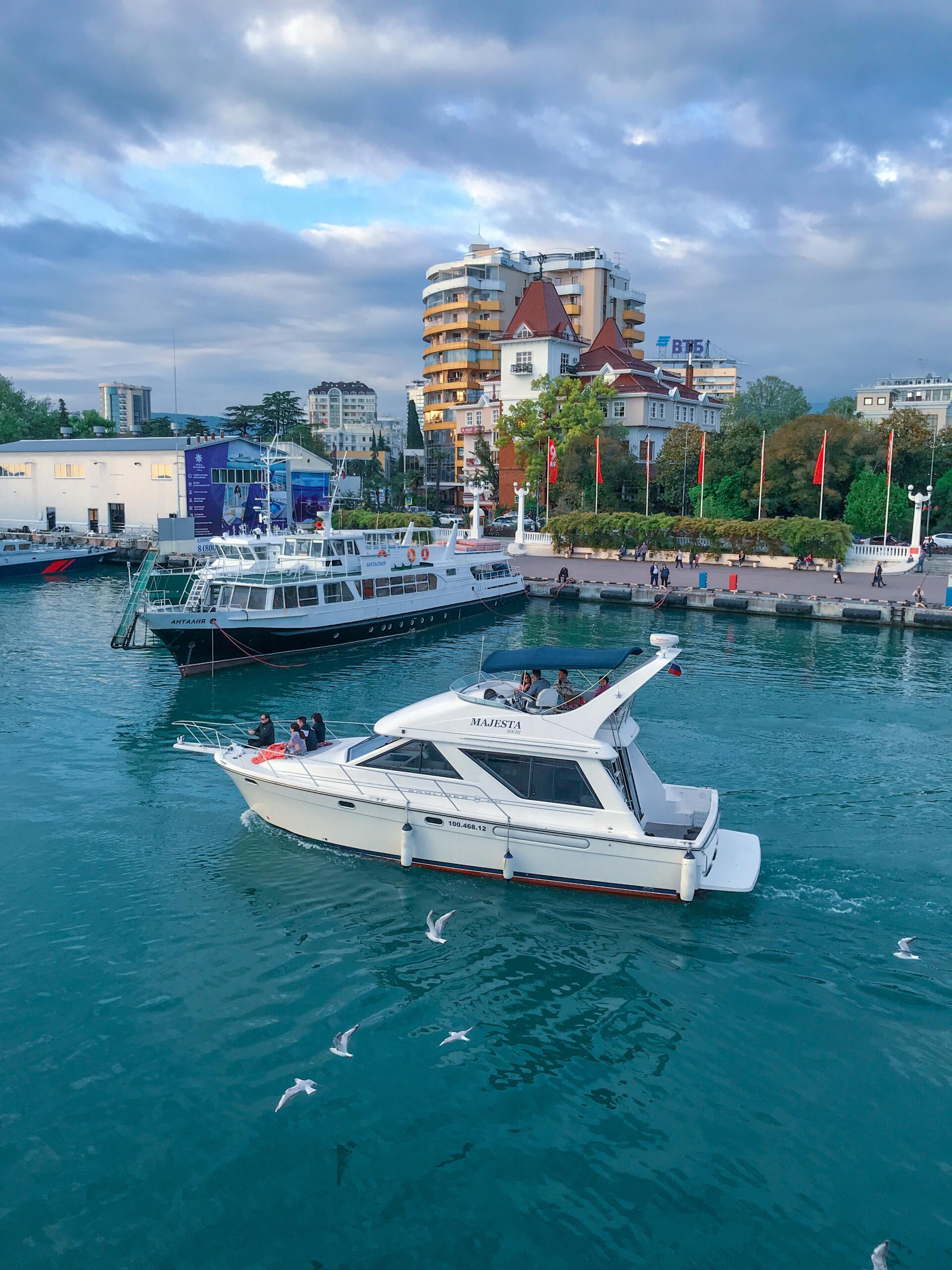 A group of boats are floating on top of a body of water.
