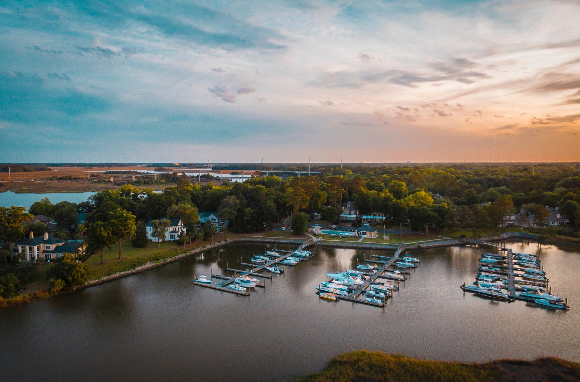 An aerial view of a marina filled with boats at sunset.