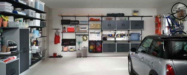 A car is parked in a garage with a bicycle on the roof.