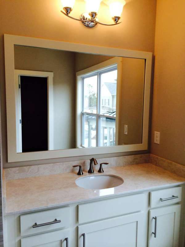 A bathroom sink with a large mirror above it