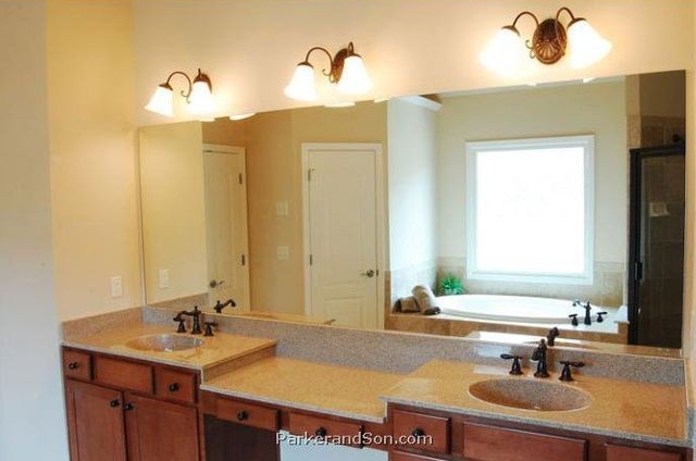 A bathroom with two sinks and a large mirror