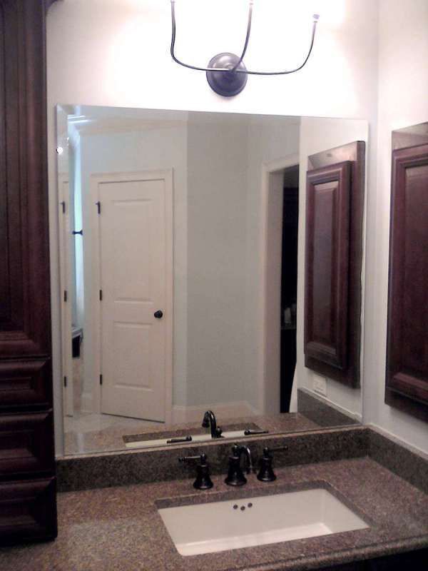 A bathroom with a sink and a large mirror