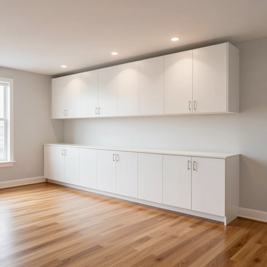 Modern white cabinets and drawers in a bright empty room with hardwood floors and recessed lighting