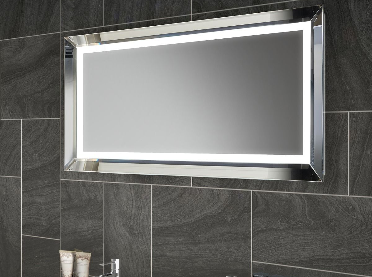 Rectangular LED mirror mounted on dark gray tiled bathroom wall.