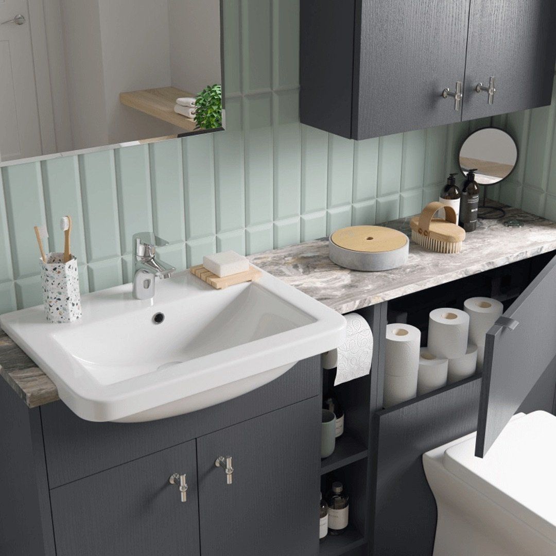 Bathroom with gray vanity, white sink, and light green tiled wall.